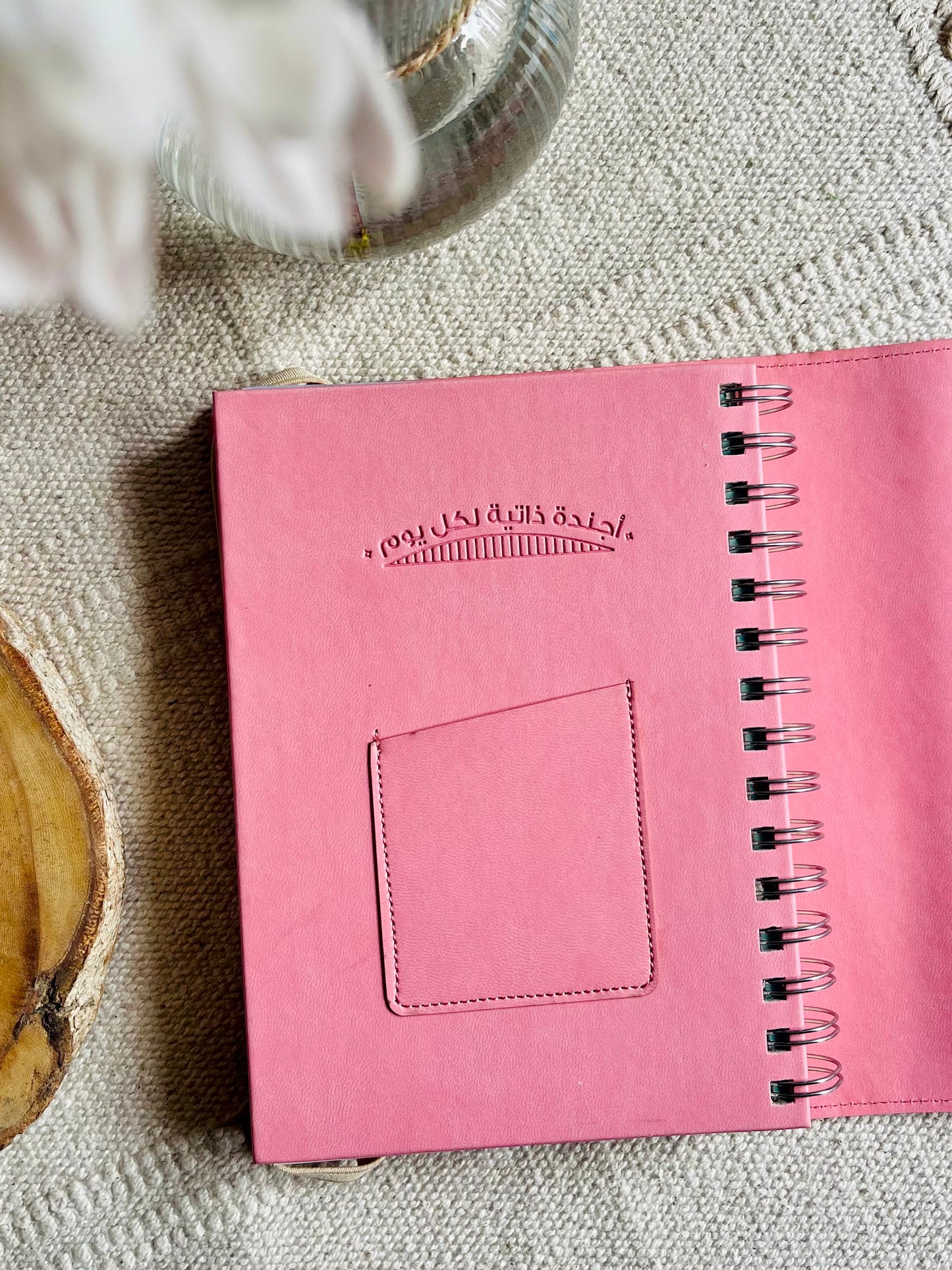 Leather spiral-bound agenda in Arabic.