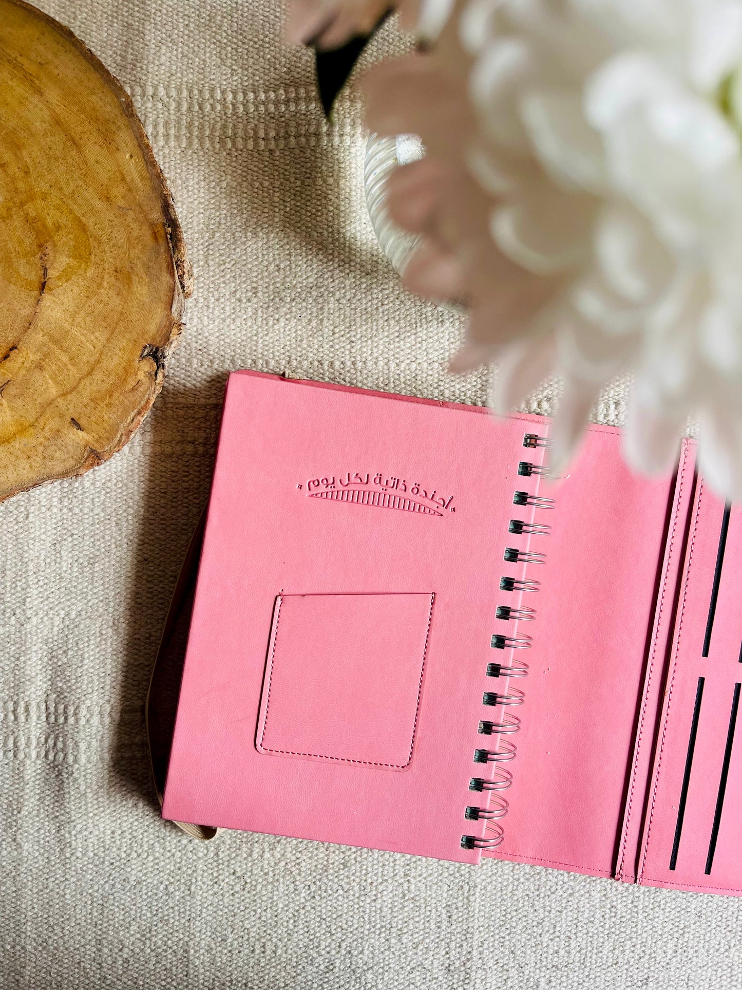 Leather spiral-bound agenda in Arabic.